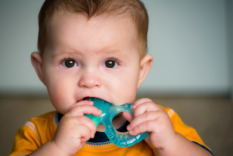 Baby with a teething toy