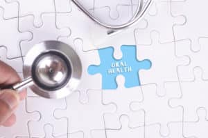 Puzzle board with the words "oral health" and a stethoscope