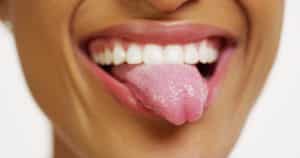 Close-up image of a person sticking their tongue out