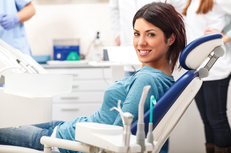 Woman in a dental chair about to have a dental cleaning