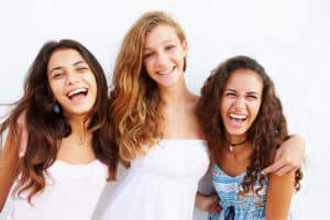 Group of girls all smiling with their braces.