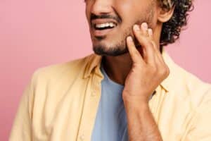Man experiencing jaw and TMJ pain in Boulder, CO