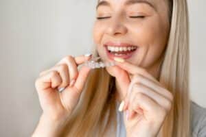 Woman with straight teeth after Invisalign treatment in Boulder, CO